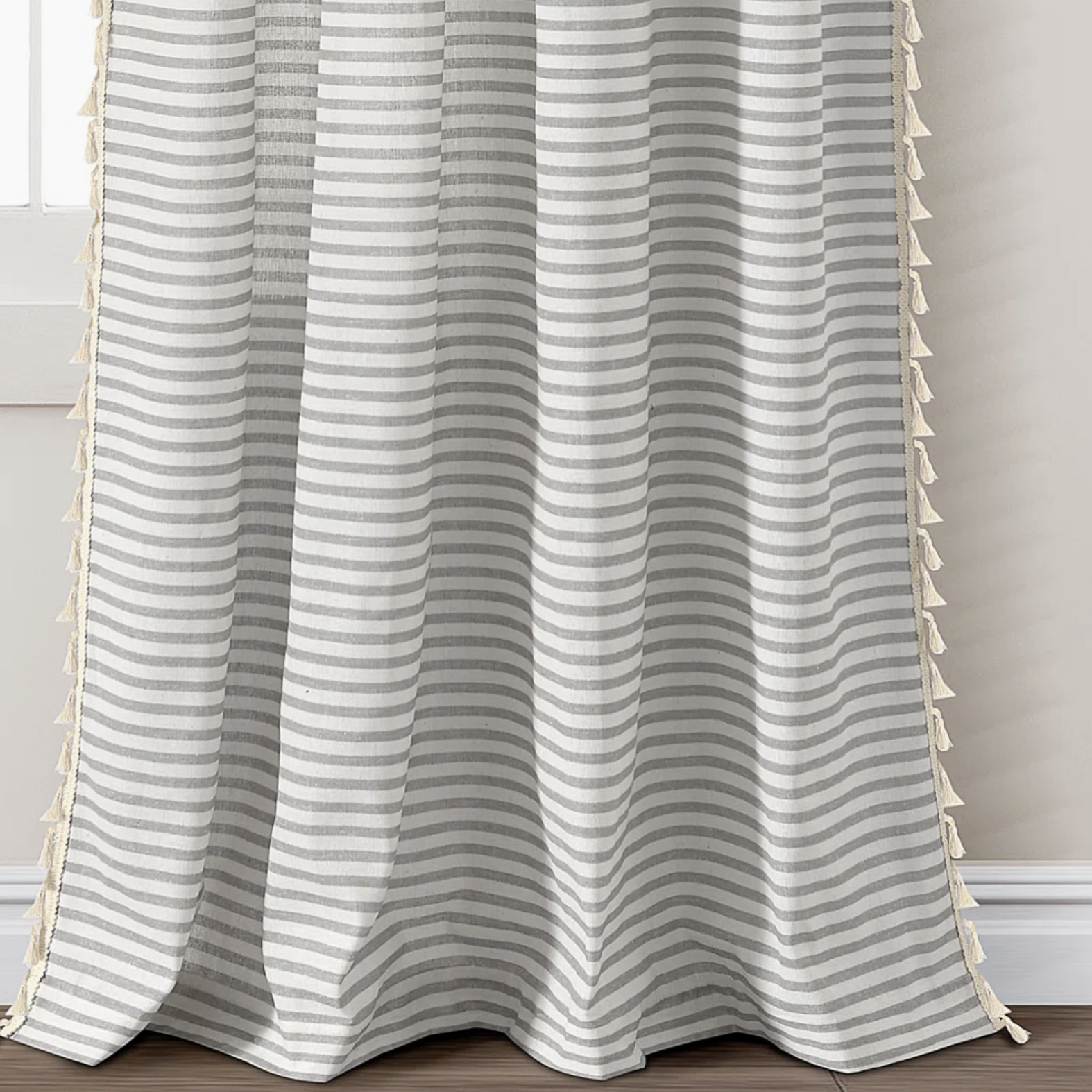 white and grey striped curtains with tassels
