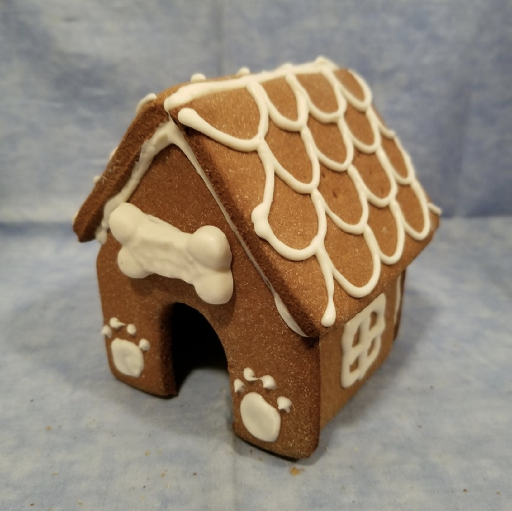 Homemade gingerbread house with dog bone and paws decorations